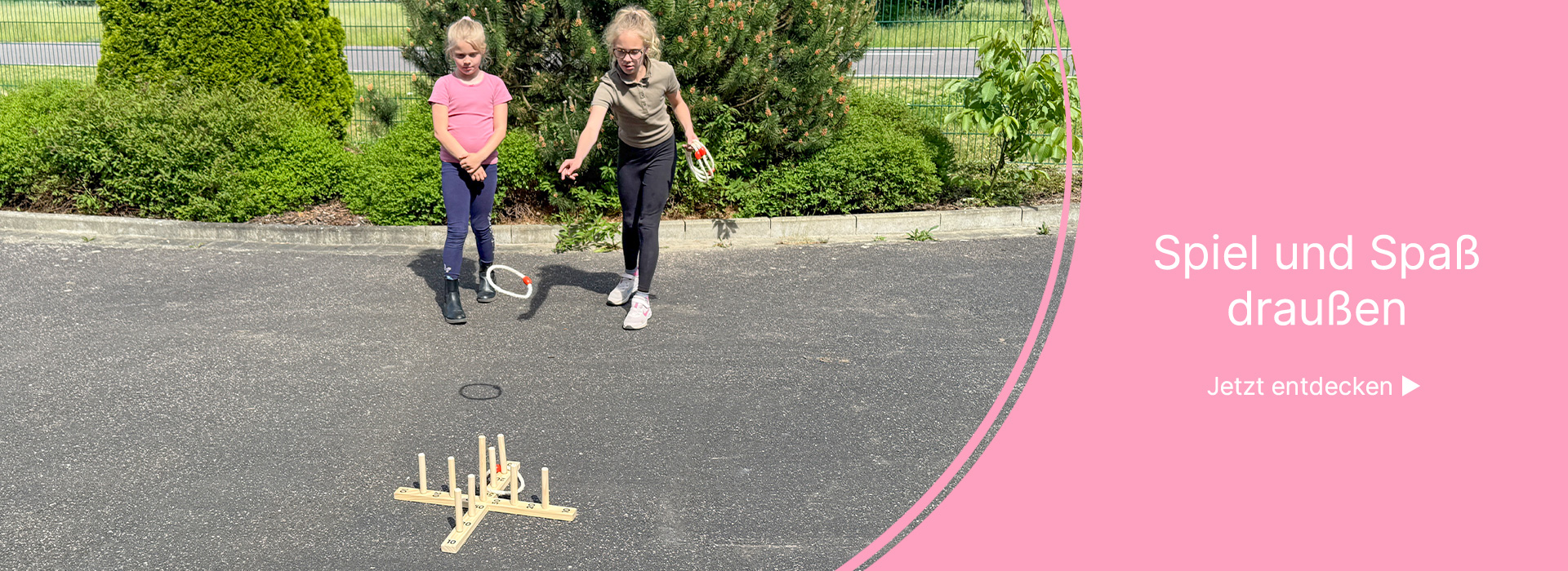Zwei Kinder spielen ein Ringwurfspiel